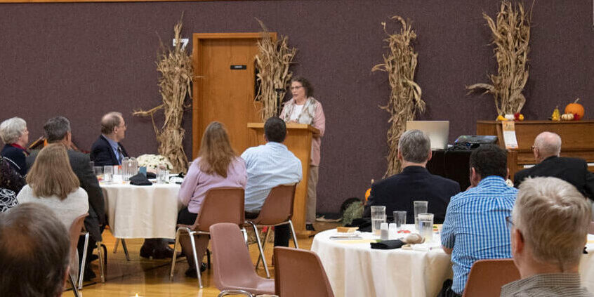 Judi Speaking to a large group